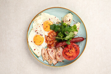Portion of classic british breakfast with beans and sausages