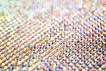 Abstract background made of rhinestones shimmering in the light.