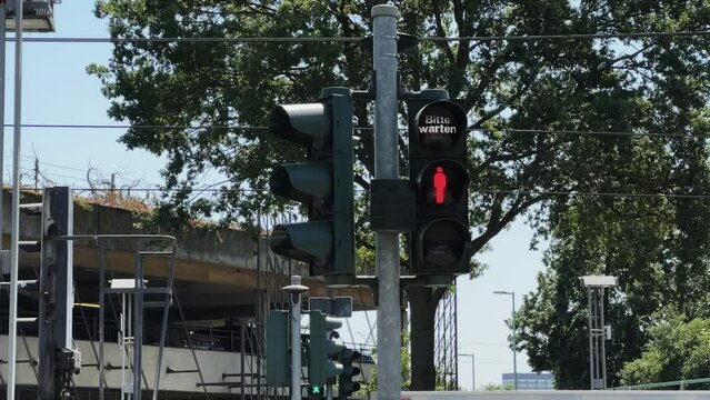 German pedestrian traffic sign on street in Berlin, Germany with warning please wait "bitte warten"