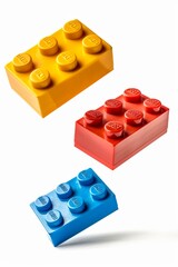 Three or 3 Toy bricks flying and isolated on white
