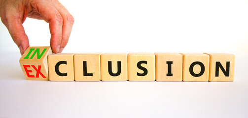 Inclusion or exclusion symbol. Concept word Exclusion and Inclusion on wooden cubes. Businessman hand. Beautiful white table white background, copy space. Business inclusion or exclusion concept.