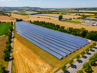 Solar field with solar panels on an agricultural field in sunshine