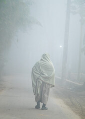 A densely foggy winter village morning