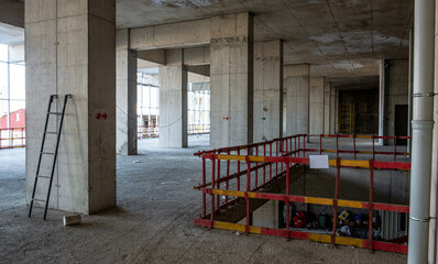 Fototapeta na wymiar Empty business building under construction. Concrete interior. 