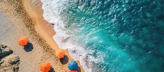 Obraz premium Tropical beach with colorful umbrellas Picture with drone. Copy space image. Place for adding text