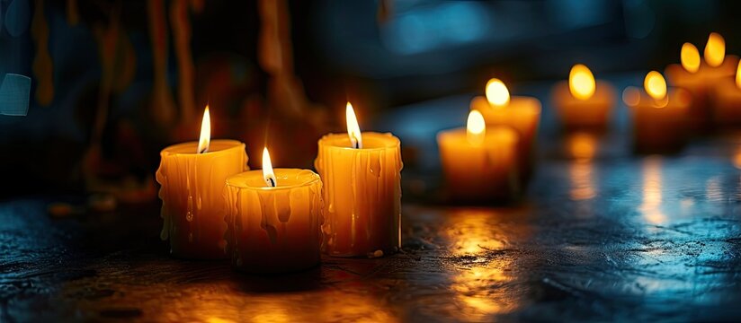Religious and devoutness scene candles burning in the dark. Copy space image. Place for adding text