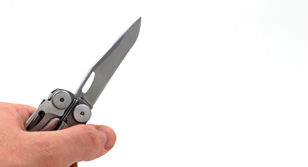 On a white background, a man's hand holds a steel multi-tool with an open knife blade. Pocket folding knife. Portable multi-tasking multi-tool with many tools. EDC concept. Tool for daily practice.