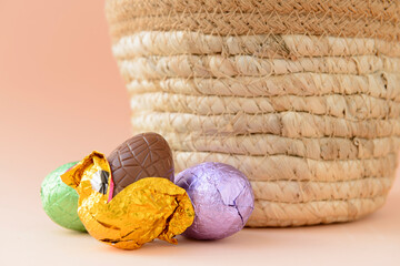 Chocolate Easter eggs next to a basket.
