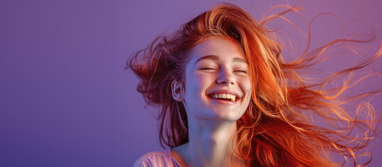 Smiling young happy woman with red long groomed hair isolated on pastel purple background with copy...