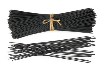 uncooked black spaghetti isolated on white background. Top view. Flat lay