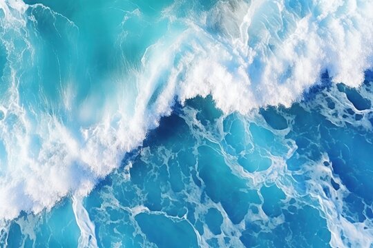  an aerial view of a blue ocean with a wave in the foreground and a bird's eye view of the water.