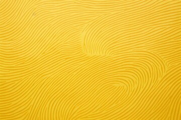  a close up view of a yellow surface with wavy lines and curves on the surface of the surface of the surface.