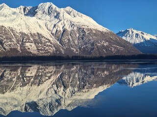 Snowy mountain reflected in the sea