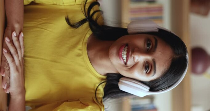 Vertical view Indian business woman talk to client using videocall application. Female applicant passing job interview remotely, blogging, social media icon, influencing, teacher lead on-line class