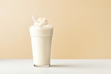  a milkshake with whipped cream and a straw in a tall glass with a straw sticking out of it.