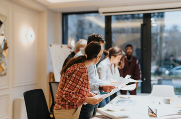 Successful multiethnic team of businesspeople working together on business strategy and analyzing profitability and productivity in the office.