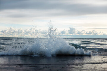 waves crashing on piers lake front in Chicago Lake Michigan with sky and clouds..