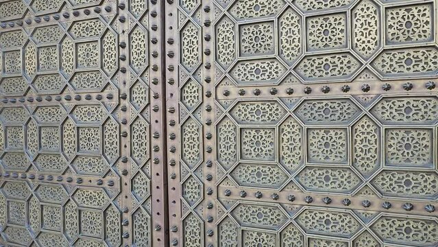 view of a traditional Moroccan copper and metal door at the Mohammed V mausoleum in Rabat Morocco
