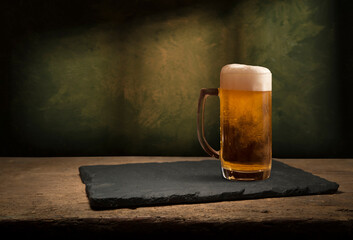 mug of beer, wheat ears, hops and beer barrel on a wooden background. High quality photo