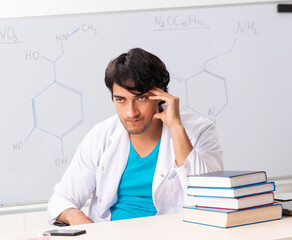 Fototapeta premium Young student chemist in the classroom