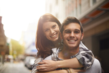 Love, portrait and happy couple hug, piggyback and together for outdoor date, bonding and fun in new city. Wellness, happiness and face of gen z man, woman or people smile for relationship commitment - Powered by Adobe