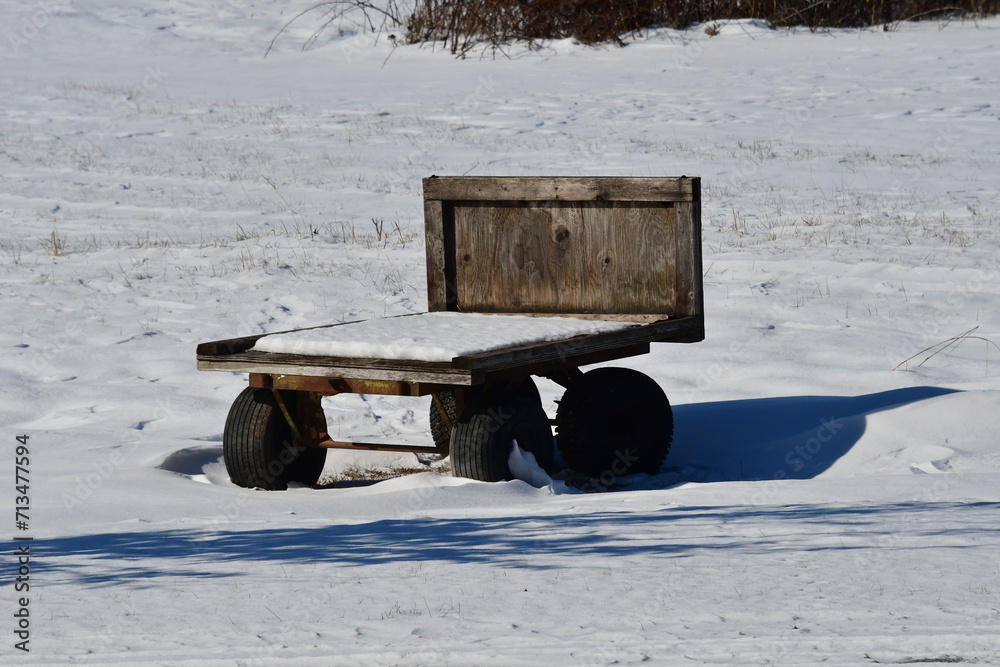 Poster wooden farm wagon in a snowy field