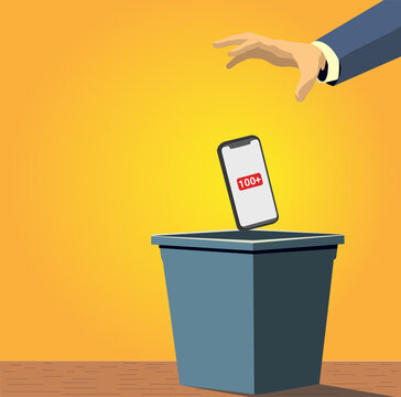 Hand dropping a mobile phone on the trash cube. Digital burnout concept