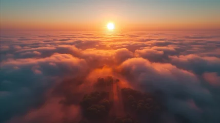 Fotobehang Mistige ochtendstond Breathtaking aerial view of a sunrise above the clouds with trees