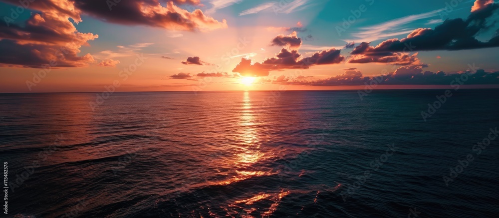 Poster aerial view over beautiful ocean during sunset top view to the ocean in summer day while sunset clos