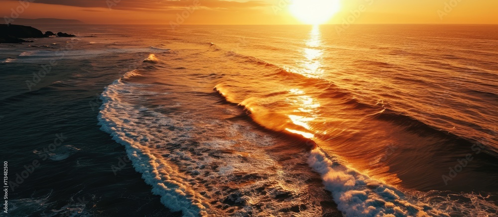 Poster aerial view over beautiful ocean during sunset top view to the ocean in summer day while sunset clos