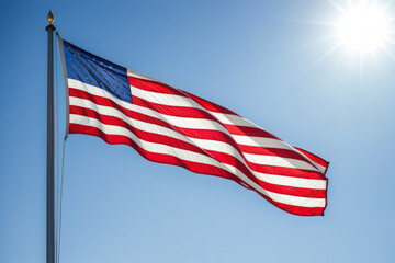 American flag develops against a blue sky. A symbol of country and freedom.