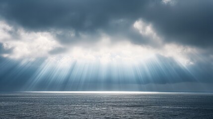 Dramatic ocean view with sun rays piercing through storm clouds - obrazy, fototapety, plakaty