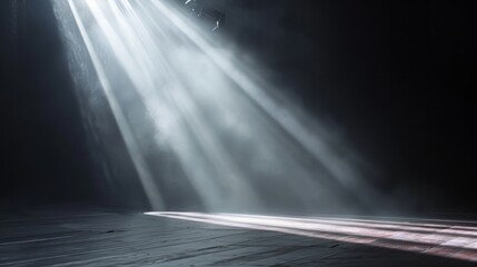 Spotlit dark stage floor with atmospheric smoke and light rays