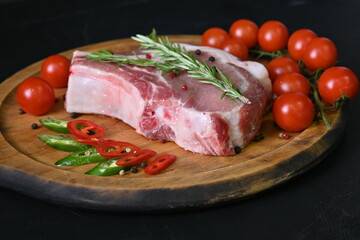 Overhead fresh meat. Pork chops with rosemary and spices on a wooden board