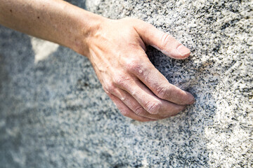 cllimbing hand on the rock