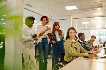 Obraz premium Multiracial people surprising colleague with disability with birthday cake