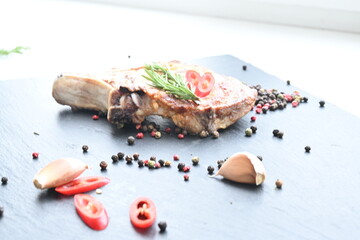 overhead view of grilled pork steak on the bone	
