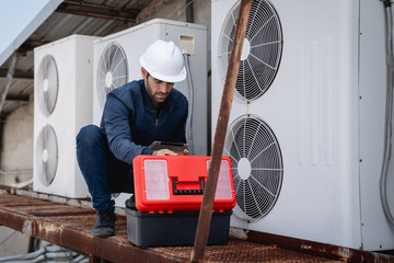 Engineers is checking the air conditioning cooling system of a major building or industrial...