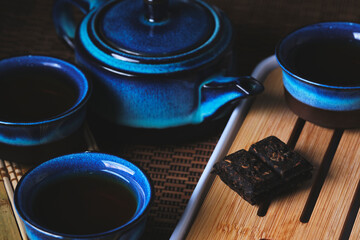 Tableware for tea ceremony . Blue tea set pottery on bamboo napkin.