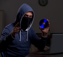 Male hacker hacking security firewall late in office