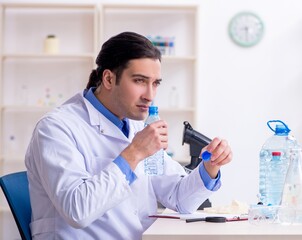 Young male chemist experimenting in lab