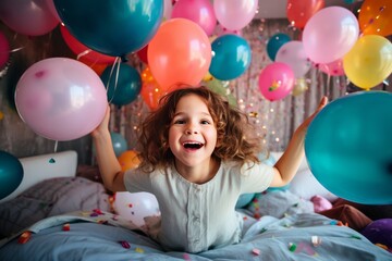 Fototapeta na wymiar A happy little girl is sitting on the bed in her room decorated with a lot of colorful balloons and smiling. The concept of holidays and happy birthday surprise. Generated by AI.