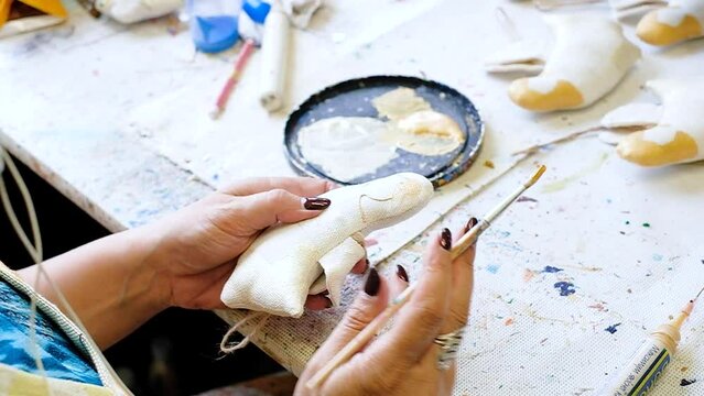 Female hands drawing a decorative angel from fabric in the workshop. Eco-friendly concept. High quality 4k footage