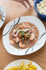 restaurant table, plate with shrimp ceviche, traditional food from Ecuador, studio photo as wallpaper, healthy soup, menu