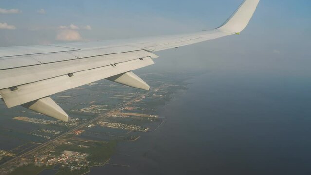 View from the passenger seat from the window of the plane to land in Bangkok. Tourism and travel concept