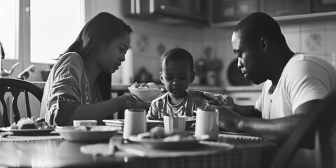 A black and white photo capturing a family enjoying a meal together. This versatile image can be...