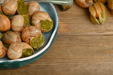 cooked snails with pesto close-up, macro snails with pesto sauce, french cuisine