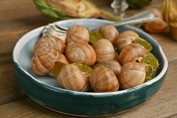 cooked snails with pesto close-up, macro snails with pesto sauce, french cuisine