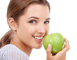 Woman, portrait and eating apple, nutrition and gut health with snack or meal, diet for weight loss on white background. Healthy food, wellness and fruit, vegan and organic with smile in studio