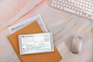 Obraz premium Online filing using digital tablet with individual income tax form 1040 is prepared by accounting office during tax season
